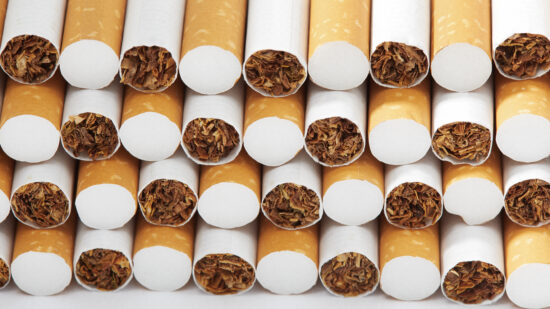 Pile stacked cigarettes against a white background.